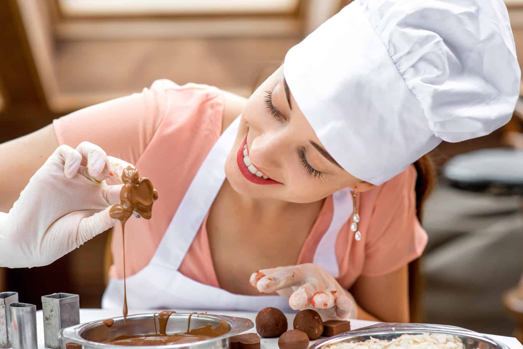 Young,Smiling,Woman,Chef,Dressed,In,White,Pinafore,Making,Handmade